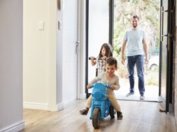 Excited Children Arriving Home With Father