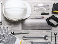 Set of construction tools on light wooden background