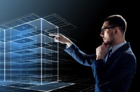 businessman in glasses with virtual building